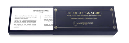 Coffret signature semi-ouvert maison arcane laissant apparaitre la carte de presentation des bougies chauffe-plat.